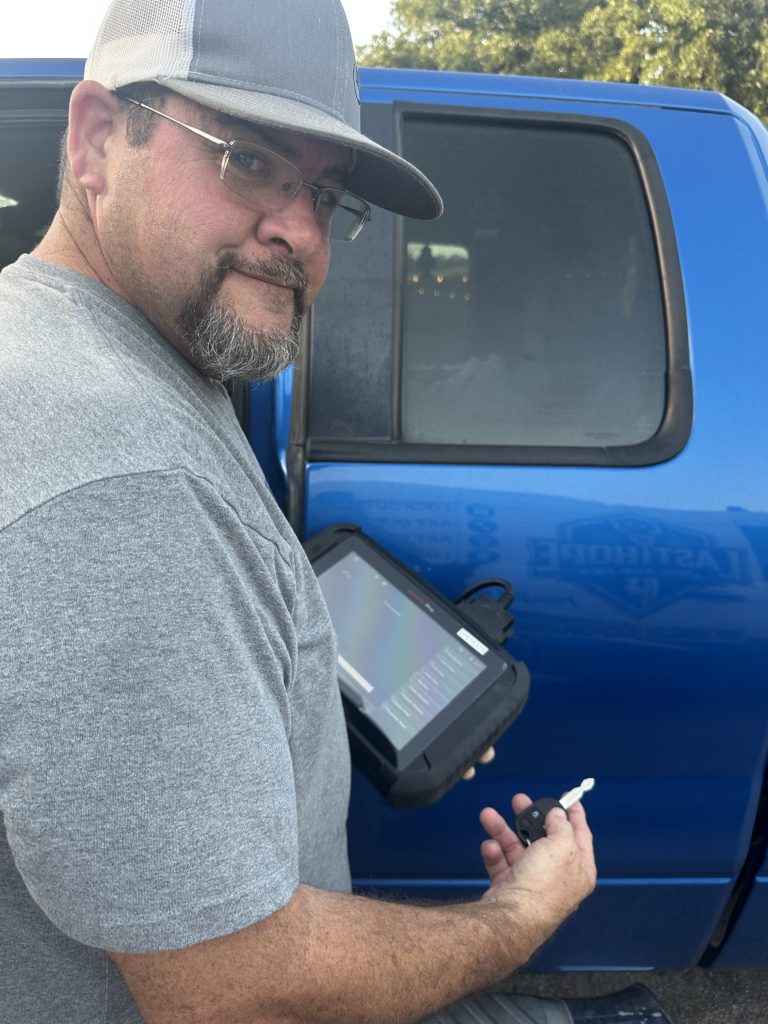 Locksmith programming a vehicle key with diagnostic equipment
