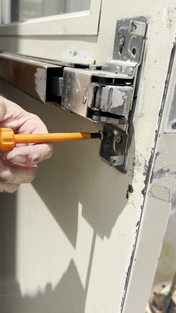 Locksmith working on commercial door hardware